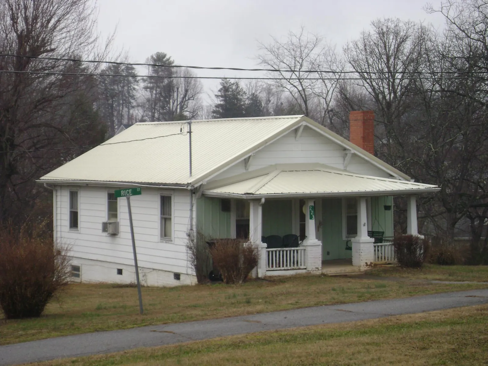 White metal roof on a craftsman bungalow at a street corner in Ekron